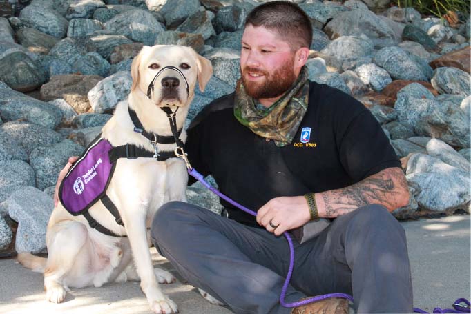 A service dog and a Veteran